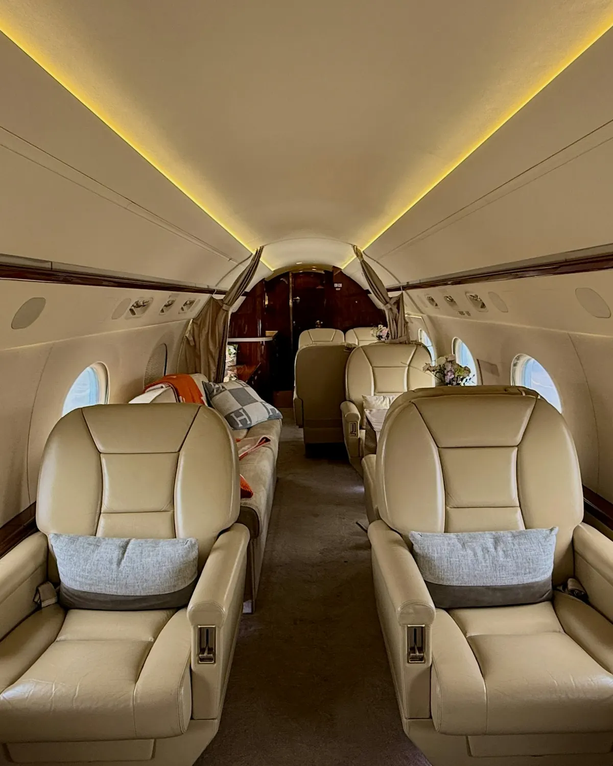 Leather club seats along the aisle of a private jet cabin