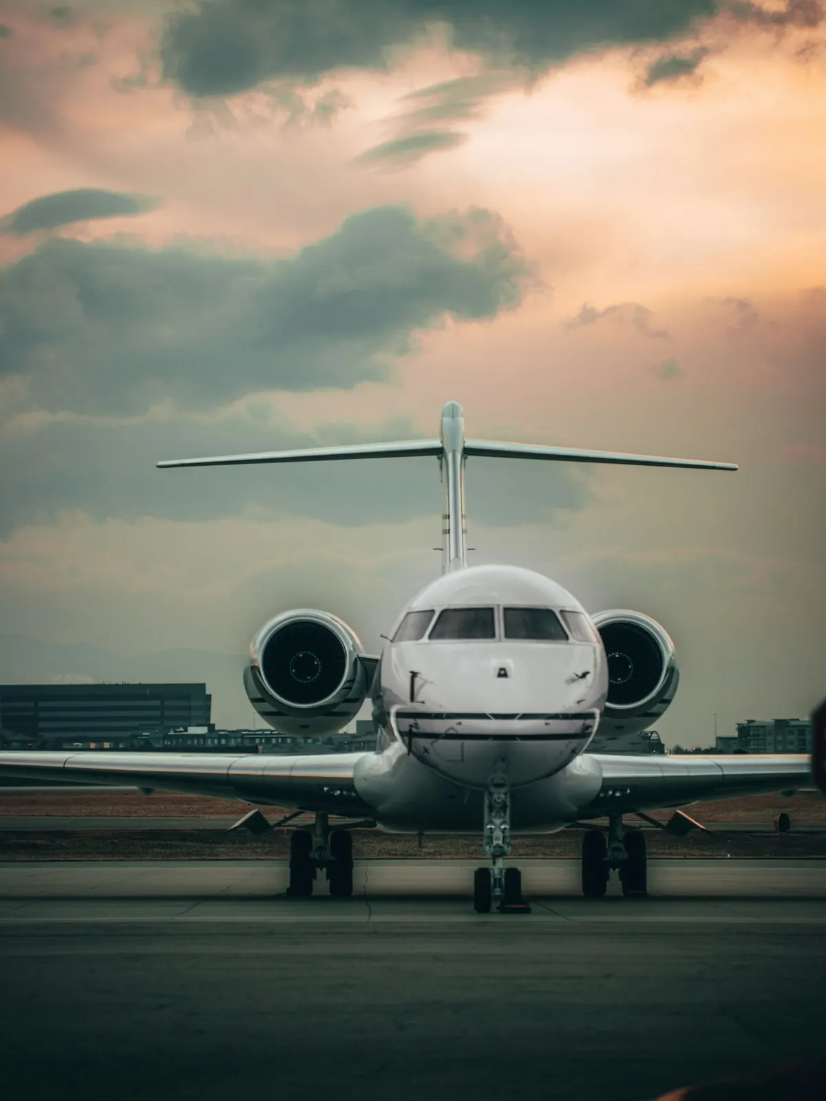 Business jet seen head-on on the ramp at dusk