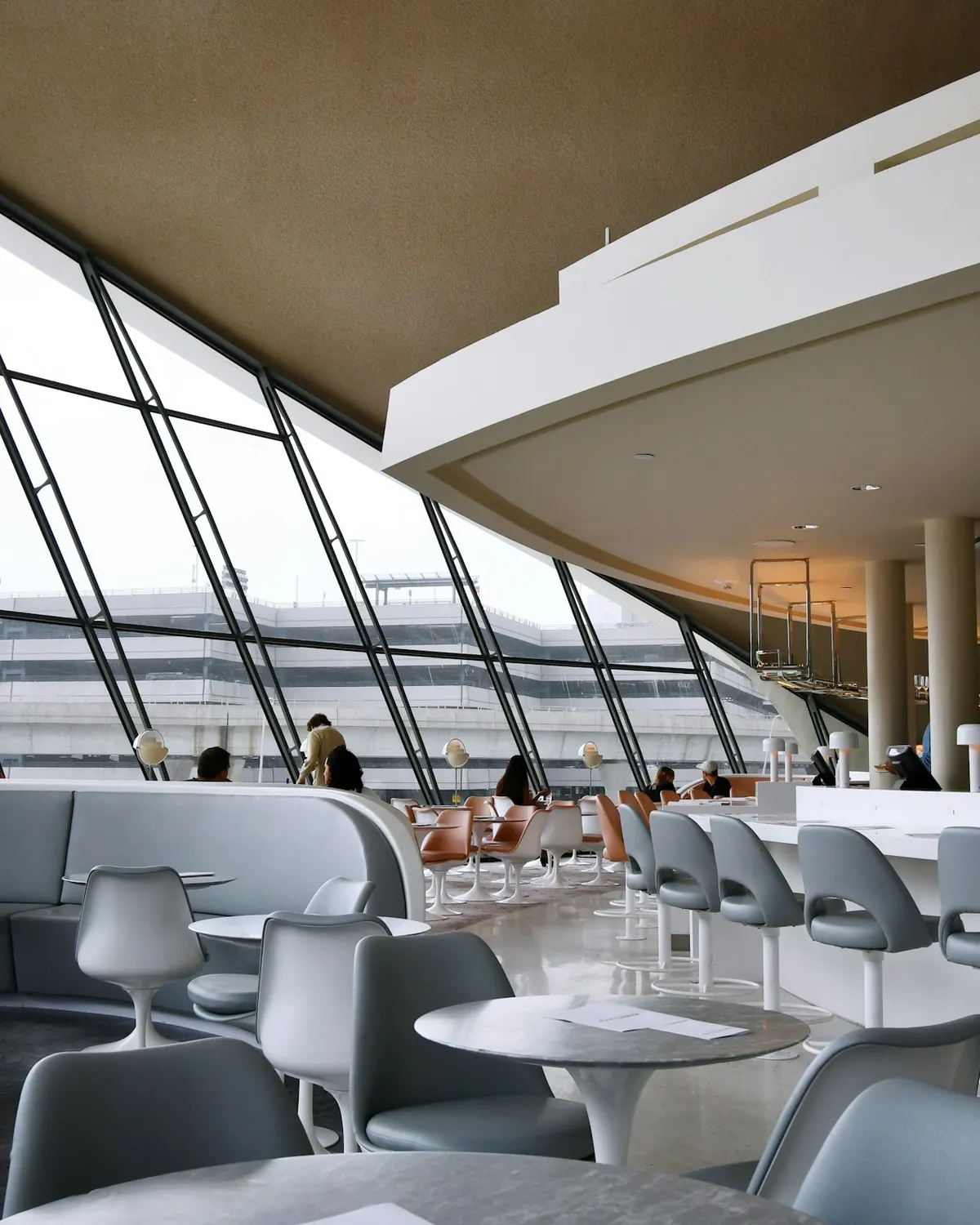 Bright private terminal lounge with tall windows onto the ramp