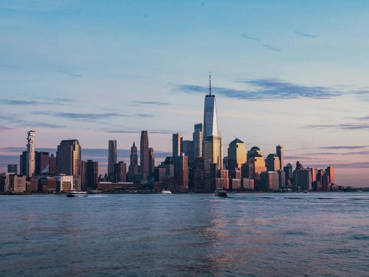 Lower Manhattan skyline across the Hudson River at dusk